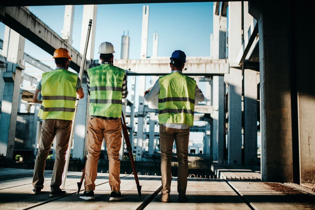 Construction engineers discussion with architects at construction or building site